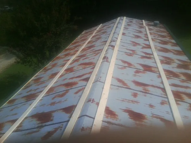 Rusted metal roof panels with new wood purlins before replacement — Storm Damage Roof Repair in Pelham by Roofing Brothers